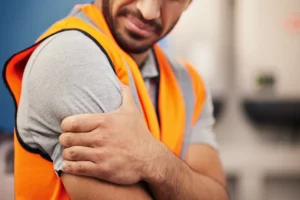 worker holding injured arm